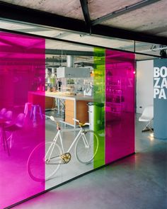 an office with colorful glass walls and chairs