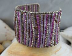 a close up of a bracelet on a stand