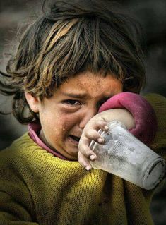 a young child is crying and holding a bottle in his hand with the caption that reads