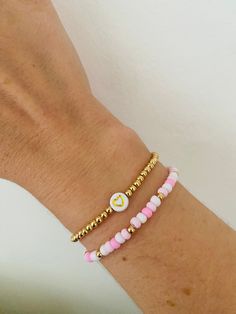 Lovely elegant set of 2 bracelets one gold with heart the other pink and gold beads.  Avaliable on 18k gold plated  Perfect little gift, bridal gift, birthday, for mothers/daughters or stacking bracelets  Best quality of care -  Keep out of water and chemicals to keep quality of bracelet Gold Heart Bracelet With Tiny Beads For Gift, Gold Heart Bracelet With Tiny Beads As Gift, Adjustable Gold Heart Bracelet With Tiny Beads, Dainty Beaded Bracelets With Heart Charm For Friendship, Gold Heart-shaped Name Bracelet With Letter Beads, Rose Gold Beaded Bracelets With Heart Charm As Gift, Gold Dainty Beaded Bracelets With Heart Charm, Dainty Beaded Bracelets For Valentine's Day, Dainty Gold Beaded Bracelets With Heart Charm