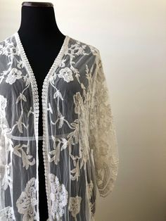 "This overlayering piece is made with soft embroidered sheer lace, features mid sleeve with scalloped sleeve edge and hem. Makes for a super sweet cover up for any outfit! ONE SIZE FITS MOST - SMALL, MEDIUM, LARGE Length: 37\" Bust: 23\" (open front, one size fits all) Armhole: 11\" Now when you order two items or more, your shipping is on us! Enter FREESHIP at checkout! ( US shipping only) And/Or Share your photo with me in the item you purchased, you will receive a $15 coupon toward your next Bohemian Fitted Sheer Cover-up, Fitted Lace Cover-up With Lace Trim, Bohemian Lace Patchwork For Spring, Fitted Bohemian Lace For Spring, Bohemian Fitted Lace For Spring, Bohemian Cream Lace For Spring, Fitted Bohemian Cover-up With Lace Trim, Fitted Bohemian Wrap Kimono, White Bohemian Embroidered Outerwear