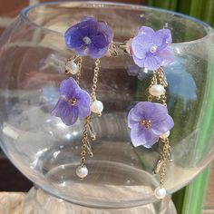 Introducing our stunning Iris Flower Earrings, featuring a charming purple color, evoking an elegant and timeless appeal. The dangles showcase intricately designed blooming flowers, adding a cute and elegant touch to your look. Crafted with hypoallergenic materials, these earrings offer a comfortable and safe wearing experience. The lightweight design makes them perfect for everyday wear or as an exquisite accessory for formal events. Ideal for various occasions, including weddings, parties, or adding a touch of elegance to your daily outfits. Elevate your style effortlessly with these lightweight, easy-to-wear, and meticulously detailed Iris Flower Earrings, suitable for any occasion that calls for a touch of vintage charm and sophistication. Elegant Lavender Flower Earrings For Gift, Mother's Day Dangle Earrings With Flower Charm, Purple Earrings As Mother's Day Gift, Lavender Flower-shaped Earrings For Gifts, Elegant Pressed Flower Drop Earrings, Elegant Purple Earrings As A Gift For Her, Elegant Purple Earrings For Her, Elegant Purple Flower Earrings, Elegant Purple Flower Shaped Earrings