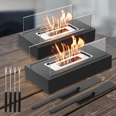 two black boxes with flames in them sitting on a table