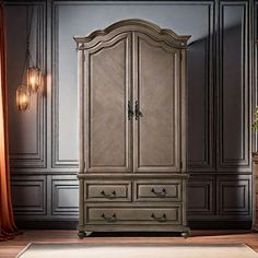 a large armoire in a room with wood flooring and gray walls, along with a rug on the floor