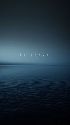 the words be brave are displayed in the dark blue water at night with an overcast sky