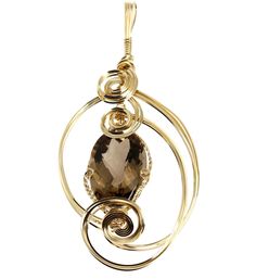 Indulge in the fine jewelry of a bygone era with this classic 65 Smoky Quartz wire sculpted pendant. Spirals of 14K Gold-filled wire encase a stunning Smoky Quartz gemstone that accents this luxurious design. Approximately 65 carats Measures approximately 4 1/2 Inches in Length x 2 Inches in Width; Bail 1/4 Inches in Width Chain not included 14K Gold-filled Gift Boxed Smoky Quartz Pendant, Wire Wrapped Jewelry Diy, Lapis Pendant, Wire Wrapping Stones, Jewelry Showcases, Diy Wire Jewelry, Quartz Pendant, Wrapped Pendant, Wire Wrapped Pendant