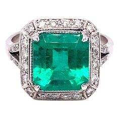 an emerald and diamond ring set in white gold