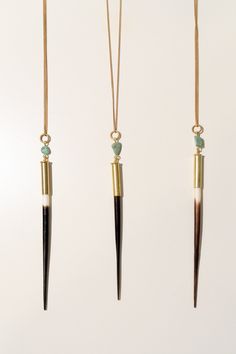 This beautiful western-inspired necklace features a natural porcupine quill set in .22 bullet casing with American turquoise.***Due to the natural variations in the quills, the tones of brown and black, and the length of the quill will vary. Approximately 85-95% of the quill will be shades of black and brown. The length ranges from 4”-6.5”*** Materials: 32" sold brass chain, recycled bullet casings, natural porcupine quills sanded smooth. Frequently asked questions: How are they made? Our top-se Beth Dutton Jewelry, Porcupine Quill Jewelry Diy, Quill Earrings Porcupine, Porcupine Quill Jewelry Naturebeads, Quill Jewelry, Native American Dentalium Necklace Shop, Porcupine Quill Necklace, Dentalium Shell Necklace, Porcupine Quill Jewelry