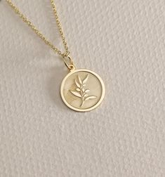 14K Real Solid Gold Olive Branch gold necklace ● Material of pendant: Solid Gold 14k ( REAL GOLD ) ● Metal Stamp: 14L ( REAL GOLD ) ● The pendant is available in 6 sizes: - 14,0 mm / 0,55 inches ( Diameter ) In the photos - 15,3 mm / 0.60 inches ( Diameter ) - 16,5 mm / 0,65 inches ( Diameter ) - 19,1 mm / 0,75 inches ( Diameter ) - 21 mm / 0,82 inches ( Diameter ) - 23 mm / 0.90 inches ( Diameter ) ( In the photos the size is 14mm / 0.55 inches Diameter ) ( Jump Ring inner diameter: 4 mm ) ● Ma Olive Branch Necklace, 14k Gold Birth Flower Pendant Jewelry, Heirloom Round Birth Flower Jewelry, Yellow Gold Birth Flower Charm Necklace, Rose Gold 14k Birth Flower Jewelry, 14k Gold Filled Yellow Gold Charm Necklace For Anniversary, Yellow Gold Round Charm Necklace With Birth Flower, 14k Gold Flower Pendant Charm Necklace For Anniversary, 14k Gold Birth Flower Necklace For Mother's Day