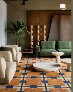 a living room filled with lots of furniture and decor on top of carpeted flooring