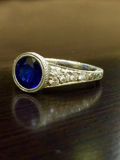 DeKara Designs Collection An Art Deco Platinum Ceylon Blue Sapphire breathtaking ring that must be seen in person to be appreciated.  Metal- 90% Platinum, 10% Iridium.Stones- 1 Round Ceylon Blue Sapphire, 1.83 Carats.  10 Round Diamonds, G color VS1 clarity, 0.36 Carats.  The craftsmanship on this ring is impeccable, and will look extraordinary on a true art lovers finger.  You will wear this ring with great joy, and love.  You will keep glancing at it because it will distract you so much!  Plea Exquisite Diamond Cut Sapphire Ring, Exquisite Diamond-cut Sapphire Ring, Classic Gia Certified Sapphire Ring, Exquisite Sapphire Diamond Ring Gia Certified, Exquisite Gia Certified Round Diamond Ring, Timeless Sapphire Diamond Wedding Ring, Timeless Sapphire Diamond Ring For Weddings, Wedding Engraved Diamond Ring With Gemstone, Exquisite Gia Certified Sapphire Diamond Ring