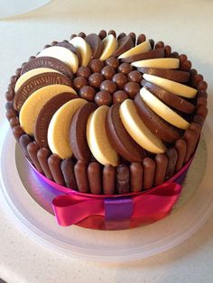 a cake that is on top of a plate with chocolates and cookies in it