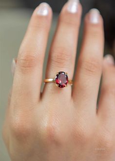 Our Garnet Gemstone Ring features a deep red faceted oval garnet set in a classic four prong setting. This January birthstone ring is Handmade in 925 silver base with a thick coating of nickel free 18k Gold Vermeil. D E T A I L S Stone size - Large - 10mm x 8mm Band size - 2mm Material: 18k thick gold vermeil over 925 sterling silver, genuine red Garnet gemstone Birthstone Month: January S H I P P I N G * Processing time - 2 business days, usually ships the next day. We are closed on Saturdays a Silver Rings With Red Stone, Birthstone Gold Ring, Gold Stone Rings For Women, January Birth Stone Rings, Gold Ring With Ruby Stone, Ruby Gemstone Ring, Oval Garnet Ring, Gold And Garnet Ring, Garnet Silver Ring