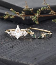 three different types of rings sitting on top of a wooden table next to some plants