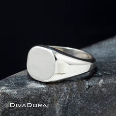 "We designed this signet ring with the look and feel of a true designer piece. The substantial weight of the solid 925 sterling silver and smooth curved edges make this a ring you will love to wear or gift with pride. We craft each piece to order and perform the laser engraving in our Los Angeles workshop. Since we control every step of the creation our team can craft a custom ring for you in only a few days! We can engrave the ring with a monogram, a single initial or work with you to create a Timeless Silver Engraved Ring Stamped 14k, White Sterling Silver Oval Signet Ring, Classic Engraved White Rings, Classic White Engraved Rings, Silver Modern Signet Ring With Engraving Option, Modern Silver Signet Ring With Engraving Option, White Sterling Silver Signet Ring Stamped 925, White Sterling Silver Signet Ring, Engraved White Gold Ring In Sterling Silver