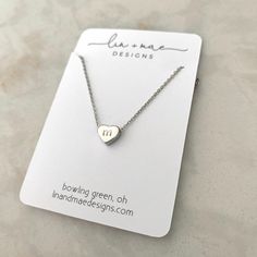 "Dainty Hand Stamped Initial Heart Necklace This hand stamped heart charm necklace makes the perfect gift! Stamp in your kids, grandkids, nieces, nephews, god-child's (or any child!) initials for a one-of-a-kind, keepsake accessory. Be sure to include what initial you would like stamped in the heart charm in the comments section when ordering!! Each heart charm finish will match the finish of the necklace chosen unless otherwise requested Listing for one necklace in Rose Gold, Silver or Gold fin Personalized White Charm Necklaces For Valentine's Day, Personalized White Charm Necklace For Valentine's Day, Valentine's Day Personalized White Charm Necklace, Adjustable Heart Charm Necklaces For Everyday, White Charm Necklace For Mom Valentine's Gift, Dainty Charm Necklaces With Heart Beads For Gift, Dainty Charm Necklace With Heart Beads For Gift, Dainty Heart Beads Charm Necklace For Gift, White Charm Necklace For Mom On Valentine's Day