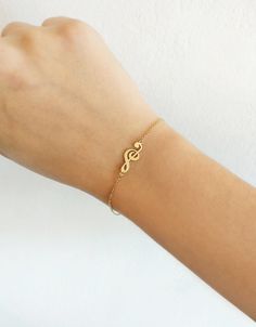 "14K 9K Gold Music Note Bracelet, Treble Clef Charm Bracelet, Dainty Music Note Bracelet, Solid Gold Bracelet, Musician Gift, Music Lover Gift, Christmas Gift, FREE EXPRESS SHIPPING Beautiful and delicate bracelet with a treble clef/note charm made in 14K or 9K solid gold. \"Music gives a soul to the universe, wings to the mind, flight to the imagination and life to everything.\" -- Plato Whisper...I love Music! -------------------------------------------------- D E T A I L S 14K Solid Gold or 9 Personalized Jewelry Band For Gift, Personalized Band Jewelry For Gift, Music-themed Band Jewelry As Gift, Music-themed Band Jewelry Gift, Music-themed Bracelet Jewelry Gift, Music Note Bracelet, Music Bracelet, Delicate Gold Bracelet, Gold Bracelet Simple