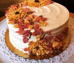 a white cake with yellow and orange flowers on it