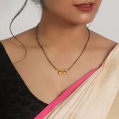 The Inspiration: A symbol of love embarking on a different glow and charm. This ethnic piece is perfect for your other half. The Design: This design is making a statement with a unique embellishment of this gold-plated musing. 
 The Stylin 
 With this mangalsutra, you can embrace the classic, traditional, and vibrant style. 
 
 925 Silver 
 
 Chain length: 43 cm +  2.5 cm adjustable  
 Charm Dimension: 14 mm x 28 mm  
 Comes with the Jewellery kit and authenticity certificate 22k Gold Jewelry For Puja, Dual-tone Gold Plated Jewelry, Dual-tone Jewelry As A Gift, Gold Dual-tone Fusion Jewelry, Gold Necklaces With Diwali Motifs, Gold Necklaces With Motifs For Diwali, Gold Necklace With Diwali Motifs, Motif Necklaces For Festivals, Motif Jewelry For Celebrations