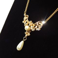 "Item: This is a fun retro necklace with Art Nouveau styling made by Coro in the 1940s. It has a nice warm gold tone setting with rhinestones and faux pearls. It's in good condition showing some wear consistent age and is signed by the maker on the back. Click Add To Cart to Buy this, click the Heart button to Favorite, and check our other listings for lots more antique and vintage jewelry! Signature: Coro, Des. Pat. Pend. Measurements: 14 1/2\" circumference Condition: 8 - Good, light wear cons Formal Retro Pendant Jewelry, Retro Formal Pendant Jewelry, Retro Pendant Jewelry For Formal Occasions, Vintage Rhinestone Pendant Necklace For Party, Vintage Gold Metal Rhinestone Necklace, Vintage Jeweled Necklaces For Vintage Events, Vintage Jeweled Necklaces For Wedding, Retro Formal Necklace With Vintage Charm, Vintage Gold Rhinestone Necklace For Parties