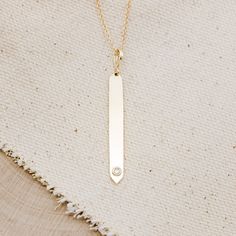 This is a gorgeous and trendy 14K gold engravable bar necklace, shown with a natural 0.03ct diamond. This is the perfect necklace to be worn on its own or layered with some of your favorite pieces. Please note that there are other available stone options. Feel free to reach out for pricing through email. NECKLACE DETAILS: Materials: 14K gold cable necklace with a single diamond in a polished finish. Stone Details: - 0.03ct 2mm natural diamond Pendant dimensions: 42x4.38 mm Chain Length: 18 Inche Minimalist Diamond Accents Bar Necklace As Gift, Minimalist Diamond Accents Bar Necklace Gift, Minimalist Bar Necklace With Diamond Accents As Gift, Minimalist Bar Necklace With Diamond Accents For Gift, Minimalist Bar Necklace With Diamond Accents, Gold Minimalist Diamond Bar Necklace, Minimalist Yellow Gold Bar Necklace With Diamond Accents, Minimalist Gold Diamond Bar Necklace, Minimalist Bar Necklace With Single Cut Diamonds For Gift