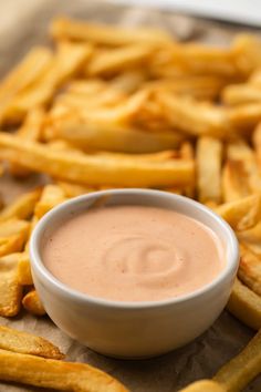 french fries with dipping sauce in a white bowl