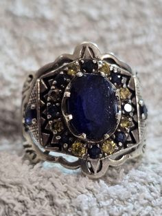 We show you A very old legend of the natural blue sapphire, and even the most luxurious of it. First toast. Rather, I am almost certain that you will only see it once in your life. Full handmade design ring That is, yes, we promised you to show you the impossible from the stones and we fulfill our promise When we are gone for a while and come back, we are looking only to collect rare stones and we do not show any words from the stones The ring is a distinctive color of blue sapphire and yellow c Antique Blue Rings With Center Stone, Vintage Blue Oval Sapphire Ring, Formal Blue Sapphire Ring With Stone Setting, Antique Sapphire Gemstone Rings, Antique Blue Multi-stone Jewelry, Vintage Sapphire Gemstone Ring, Collectible Blue Sapphire Ring Hallmarked, Oval Blue Multi-stone Sapphire Ring, Collectible Hallmarked Blue Sapphire Ring