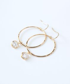 "Light catching CZ drops are suspended from hammered 14k Gold Filled hoops with our new Chloe Hoop Earrings. This classic design is perfect for daily wear, a night out or a wedding party. All gold elements, including CZ settings, are made from superior quality 14k Gold Filled and will endure for years to come. You may also like these styles from the Chloe Collection: CZ Huggie Hoops >> https://www.etsy.com/listing/1155443088 CZ threaders >> https://www.etsy.com/listing/770882053 MATERIALS: 14k G Gold-tone Clip-on Hoop Earrings For Gift, 14k Gold-filled Gold-tone Hoop Earrings, Hammered 14k Gold-filled Hoop Earrings, Rose Gold 14k Gold-filled Hoop Earrings, Gold Hoop Crystal Earrings Nickel-free, Gold Filled Hoops, Earrings Crystal, Vermeil Jewelry, Crystal Drop Earrings