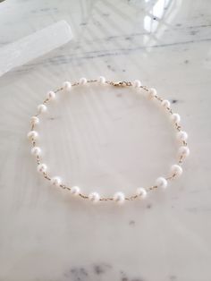 This handmade necklace is perfectly on trend and yet completely timeless and classic. Genuine freshwater pearls are hand wrapped with top quality materials. 925 sterling silver or 14k gold fill. These pearls are imperfectly round, so charming and natural. Hypoallergenic, lead and nickel free. Excellent for sensitive skin! Comes packaged in a gift box. ~M A T E R I A L S ~ Choose from- * 925 Sterling silver *14k Gold fill *14k Rose gold fill **What is 14k Gold-fill?** Gold fill does not tarnish o White Single Strand Pearl Necklace With 14k Gold Filled, Dainty Single Strand Akoya Pearl Necklace, Dainty Akoya Pearl Single Strand Necklace, Elegant Choker With Round Pearl Beads, Classic Pearl Drop Choker Necklace, Minimalist Pearl Charm Choker Necklace, Dainty Single Strand Pearl Necklace In 14k Gold, Elegant 14k Gold Filled Choker Gift, Minimalist Pearl Choker Necklace