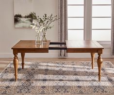 a wooden table sitting on top of a rug