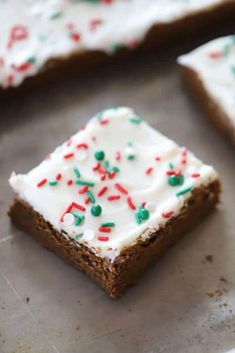 some kind of cookie with white frosting and sprinkles