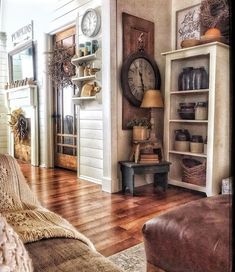 a living room filled with furniture and a clock on the wall