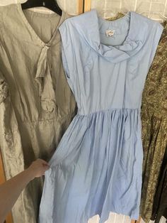 Lot of 4 1950’s dresses1. Light blue cotton dress, has underarm discoloration. Bust 39” waist 27” hips free2. Green paisley, major sun fading, see photos. 42” bust 28” waist hips free3. Grey linen dress, small stains throughout. 50” bust 40” waist 48” hips4. Green and brown cotton paisley striped dress. Missing all but two buttons. Bust 36” waist 25” hips free.All being sold as is, will need repairs Light Blue Vintage Cotton Dress, 1950s Style Blue Summer Dress, Light Blue Retro Summer Dress, Vintage Light Blue Cotton Dress, Retro Light Blue Summer Dress, Sleeveless Blue Dress For Vintage Fashion, Blue 1950s Style Summer Dress, 1950s Blue Summer Dress, Vintage Light Blue Knee-length Dress