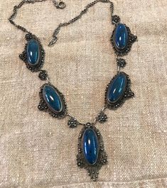 "An Antique silver finely hand wrought Swiss Lapis(dyed Jasper-the period stone used in these early Italian pieces), Necklace-Probably a souvenir of the Grand Tour-late 1800s to early 1900s. Fratelli Peruzzi dates back to the 1880s-Florence I believe on the Ponte Vecchio Bridge location.  Condition I see no problems, spring ring clasp works, oval cabochon stones are securely bezel set, the detailed fineness to these early Peruzzi pieces is difficult to believe-the masterful soldering to construc Hand Forged Sterling Silver Necklace In Antique Silver, Antique Silver Hand Forged Sterling Silver Necklaces, Hand Forged Antique Silver Sterling Necklace, Ornate Formal Necklace With Oxidized Finish, Formal Cabochon Pendant Necklace, Vintage Hand Forged Round Jewelry, Hand Forged Vintage Jewelry, Unique Oval Jewelry For Ceremonial Occasions, Antique Sterling Silver Necklace With Oxidized Finish