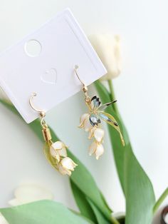 These unique handmade earrings feature a beautiful blossom flower and butterfly design. Crafted from high quality materials, they make a perfect gift for the special someone in your life. Show your loved one how much you care with these stunning blossom flower earrings. Detail: - Size of earring: 40mm Material: flowers - resin; ear wires - 18k gold The Handmade Flower Earrings are sold in pairs of two earrings. Bridal Jewelery, Unique Handmade Earrings, Butterfly Design, Wire Earrings, Lily Of The Valley, Bridesmaid Earrings, Handmade Flowers, Flower Earrings, Gifts For Girls