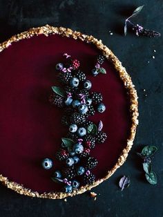 an image of a pie with berries on it and the words dark berries tart with basil