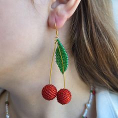 Stand Out with These Playful Cherry Earrings! Who's this for? Looking for a unique accessory to add a touch of personality to your outfit? These cherry earrings are the perfect choice for anyone who loves: Fun and playful jewelry Bright and vibrant colors Unique and eye-catching designs Comfortable and lightweight accessories Characteristics: Handmade with high-quality Czech glass beads Features vibrant red and green cherries Lightweight and comfortable to wear Gold-plated findings for a touch of elegance Versatile and can be paired with any outfit Why it's worth buying: Adds a pop of color and personality to any outfit Makes a perfect gift for a friend or loved one Crafted with attention to detail and high-quality materials Affordable and stylish Ready to add a touch of whimsy to your war Trendy Handmade Cherry-colored Jewelry, Handmade Cherry Jewelry For Party, Cherry Dangle Earrings With Ear Wire, Cherry Color Dangle Earrings, Cherry Dangle Earrings For Party, Fun Red Beaded Earrings For Gift, Cherry Color Dangle Earrings For Party, Trendy Dangle Beaded Earrings With Ear Wire, Trendy Beaded Dangle Earrings With Ear Wire