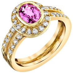 This pretty ring features a vibrant pink sapphire and sparkling diamonds in an 18k yellow gold setting that is perfect for everyday wear! The pink sapphire has been bezel set and framed with a halo of white diamonds, with two rows of additional diamonds continuing down the split band for double the luxurious effect! This elegant ring can be worn day and night, on either hand! Pink sapphire, 5.50 x 7.00mm, 1.14 carats 36 round brilliant cut diamonds, .57 carat total Ring size 6.5 Complimentary si Pretty Ring, Bezel Set Ring, Gold Ring Designs, Yellow Gold Setting, 18k Yellow Gold Ring, Pretty Rings, Halo Diamond Engagement Ring, Elegant Ring, Halo Engagement Ring