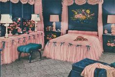 a bedroom decorated in pink and black with flowers on the bed, dressers, lamps, and mirror