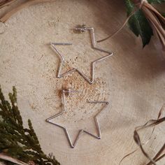 A little bit of the night sky for your ears! To go along with the moon hoop earrings, I was asked to make some stars as well. These sterling silver hoops are about 1.5 inches wide and about 1.5 inches tall. Wonderful every day earrings that will go with your favorite outfit! Custom made to order designs such as these star hoop earrings will take me about 1-2 weeks to create before they are mailed off to you. Celestial Sterling Silver Hoop Earrings With Star Charm, Celestial Sterling Silver Star Hoop Earrings, Sterling Silver Celestial Hoop Earrings With Star Charm, Silver Star-shaped Celestial Hoop Earrings, Handmade Star-shaped Hoop Earrings For Gift, Celestial Handmade Hoop Earrings As Gift, Handmade Celestial Hoop Earrings As Gift, Nickel-free Sterling Silver Star Hoop Earrings, Handmade Sterling Silver Celestial Hoop Earrings