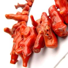 several pieces of red candy sitting on top of a white surface