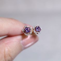 "These stylish earrings have a stunning bright color and the Amethyst is surrounded by a flower shape of shimmering diamonds. Perfect as a gift for her. Features * Made to Order. * Metal: 925 Sterling Silver * Custom Color: Rose Gold, Gold, Silver * Main Stone: Amethyst, 4mm dia Round Shape, 2pcs * Side Stone: Cubic Zirconia * Flower Measurements: around 6.64*6.60 mm Matching Amethyst Ring: https://etsy.me/32Rg6m4 Be sure to hit \"favorite\" on the right so it remains in your favorites list and/ Flower Shaped Earrings With Prong Setting, Flower-shaped Earrings With Prong Setting For Gift, Gift Earrings With Flower Shape And Prong Setting, Round Purple Earrings With Gemstone Accents, Purple Gemstone Accented Round Earrings, Purple Gemstone Accent Round Earrings, Purple Round Earrings With Gemstone Accents, Dainty Purple Round Earrings, Lavender Flower-shaped Earrings For Gifts