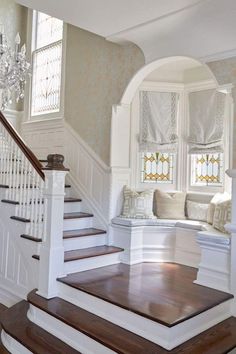 the stairs in this house are made of wood and have been painted white with brown trim