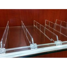 three clear acrylic boxes on top of a wooden table