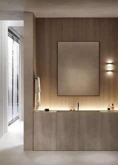 a bathroom with two sinks and a large mirror on the wall next to it's lights