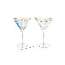 two martini glasses sitting next to each other on a white surface with gold rims