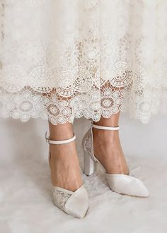 the bride's shoes are all white and have lace on them