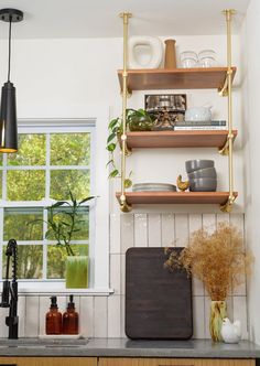 the shelves in the kitchen are filled with dishes