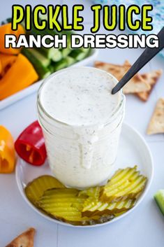 pickle juice ranch dressing on a plate with crackers and vegetables in the background