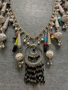 vintage funky handmade bohemian chic silver plate necklace. I have recyceld this beautiful old siver plate necklace that was made in the 1960's giving it a great bohemian chic look and a slight splash of color. The necklace is metal and silver plate and the beads are hand made glass. the necklace measures about 24 inches and is quite large with all its adonrnments. please note most of the vintage jewelry in the is section has been rescued recycled or repaired. which means they may have small alt Metal Beaded Necklaces With Dangling Beads, Handmade Metal Necklace For Festivals, Bohemian Metal Necklaces For Jewelry Making, Bohemian Multicolor Nickel-free Beaded Necklaces, Nickel Free Multicolor Bohemian Beaded Necklaces, Nickel Free Multicolor Beaded Necklace For Festivals, Handmade Sterling Silver Beaded Necklaces For Festivals, Silver Metal Beaded Necklace With Dangling Beads, Nickel-free Multicolor Beaded Necklace For Festival